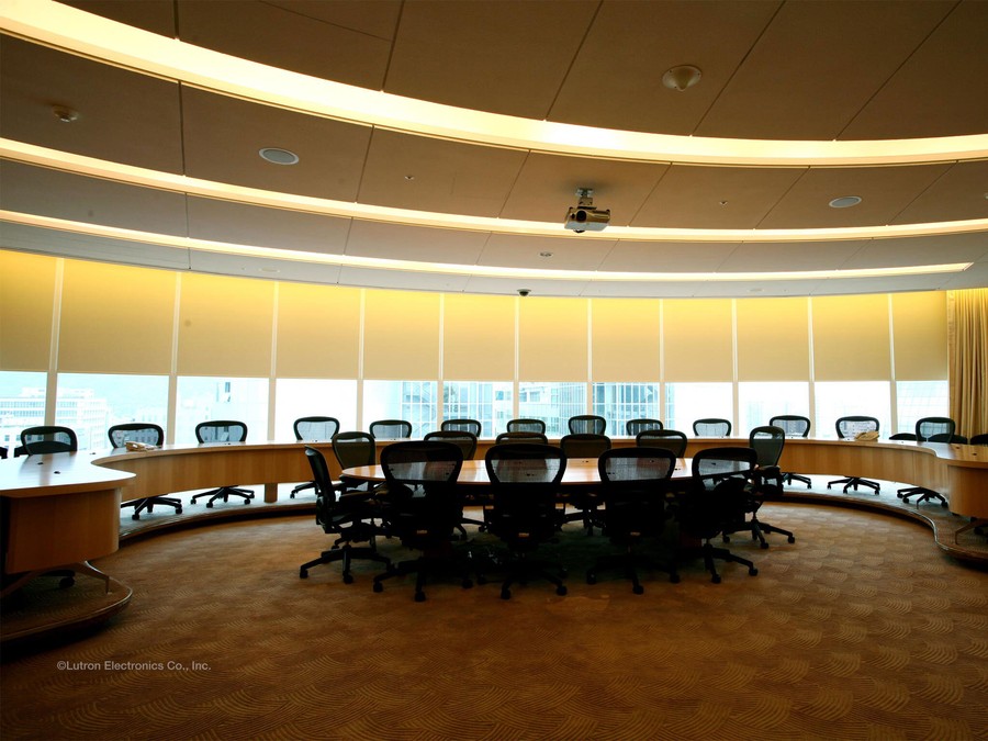 A conference room featuring Lutron motorized blinds on multiple windows.