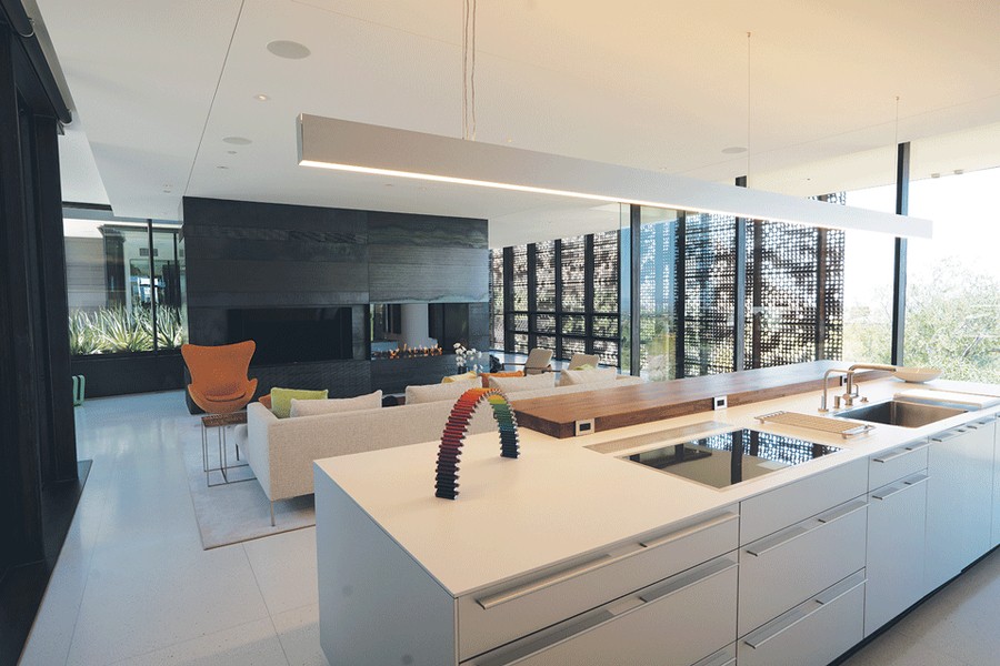  A kitchen and living room space featuring Sonance in-ceiling speakers.